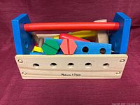 Front view of toolbox showing brand name and mixed tools inside