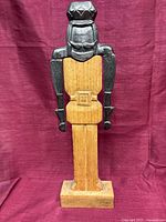 Full front view showing metal soldier figure on wood column and base