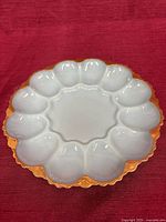 Top view showing twelve oval wells and scalloped rim