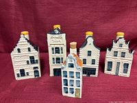 Front view of five Delft Blue canal house bottles