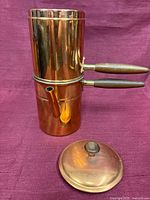 Both copper pots stacked showing exterior surfaces and lid