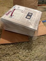 Stack of bagged collector pages showing coin apertures