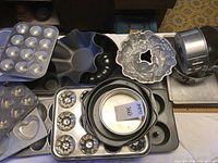 Wide view of assorted bakeware pans on table