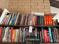 Two-shelf view showing most of the books in the lot