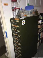 Front and side view of full cabinet with containers on top