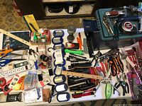 Overhead view showing all flashlights, hand tools, rulers, office items and storage box