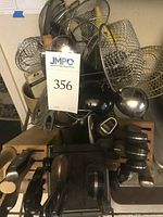 Assortment of utensils in container with knife block visible