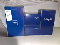 Four Mikasa branded boxes including two tall and two smaller boxes