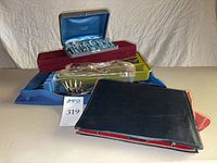 Overview of boxed flatware and cases on table