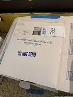 White envelope marked Important Materials Enclosed with lot