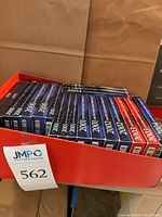 Stacked boxed proof sets showing years 2000-2005 in red tray