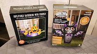 Both boxed inflatables: dachshund with pumpkin and vampire bat