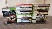 Full lot: two stacks of Xbox 360 cases and Dead Space 2 Collector’s Edition box