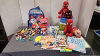 Overview of entire lot with backpack, plush toys, figurines and books