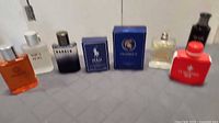 Group shot of eight cologne bottles and boxes