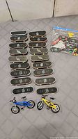 Full lot showing fingerboards, bikes, parts bag