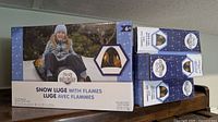 Front view of boxed DayPlay Snow Luge with Flames showing product image and branding