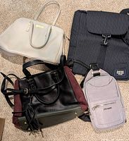 Overview of four handbags on carpet