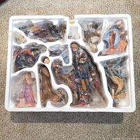 All twelve figurines wrapped in original foam tray
