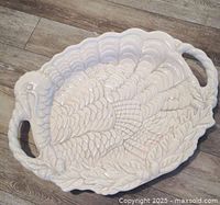 Top view showing turkey relief design, handles, overall condition