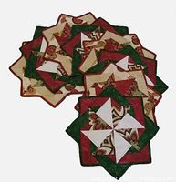 Stack of eight star-shaped quilted placemats showing front holiday pattern