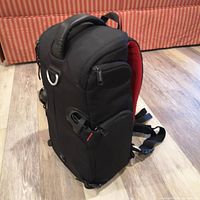 Left side view of Kata 3N1-20 bag showing exterior pocket, shoulder strap and hip belt