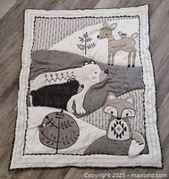 Full view of quilt front showing animal appliqués and color scheme