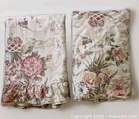 Both folded sheets side-by-side; flat sheet with ruffle on left, fitted sheet on right