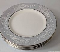 Stack of eight Royal Doulton Valleyfield salad plates showing rim design