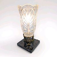 Full view of crystal hurricane lamp on marble base
