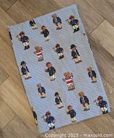 Sheet laid flat showing full pattern of Polo Bears on blue stripe background