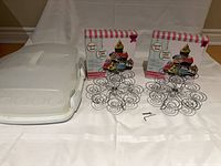 overall lot showing two boxed cupcake stands, assembled spiral tops, and plastic carrier