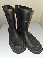 Front and side view of both black Crocs rain boots