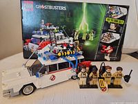 Box, assembled Ecto-1 model, four minifigures displayed