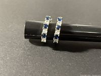 Front view of both hoop earrings showing stone pattern