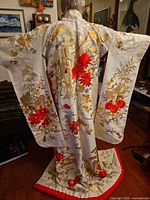 Full back view showing overall design, embroidery and hem padding