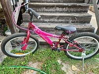 Full left side view of pink Garneau kids bike showing overall condition
