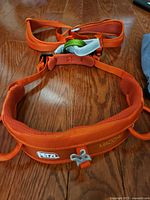 Front view of orange Petzl Macchu harness