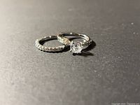 Both rings side by side on dark surface