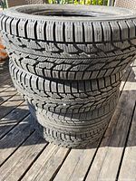 Stack of four 185/60R14 tires showing tread and sidewall markings