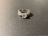 Ring on black background showing overall design and center stone