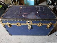 Full view of blue trunk showing front hardware and size