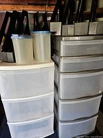 Two drawer towers with file organizers and Tupperware on top