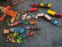 Overview of full lot showing engines, rolling stock, boat, destination, trees and figures