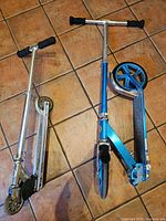 Both scooters folded out on floor