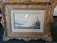 Front view showing entire framed artwork and ornate gilt wood frame