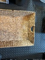 Light tan rectangular wicker basket interior showing weave and side handle