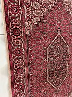 Close-up of rug corner showing border design and tight weave