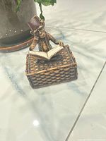 Front view of monkey figurine reading book on trinket box