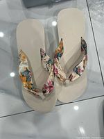 Top view of floral flip-flop pair